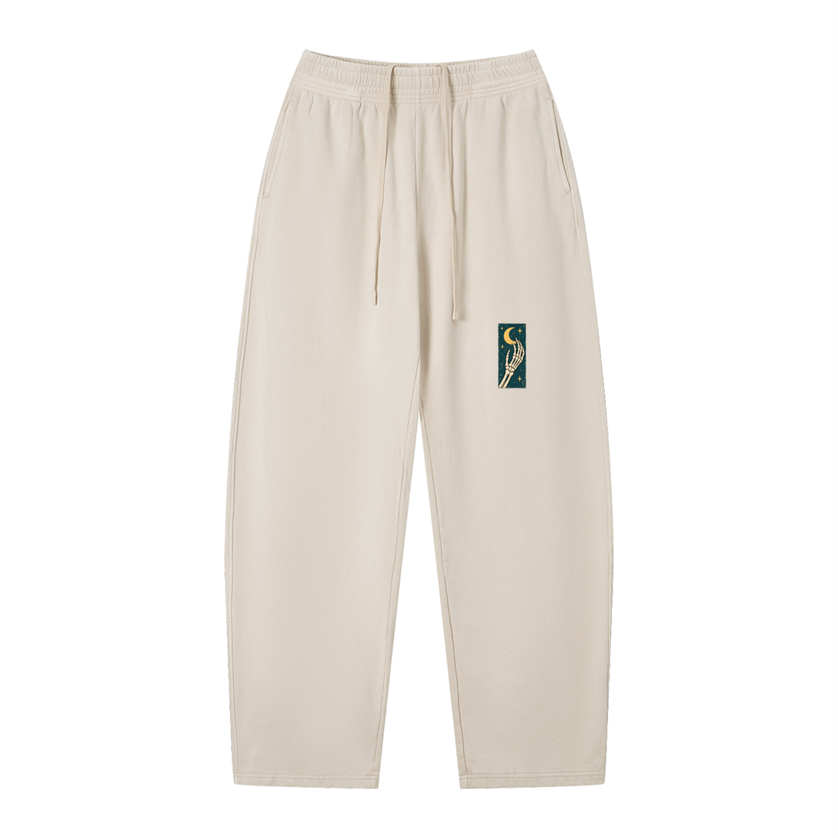 EvoCore Dead Tired Club Washed Sweatpants in Apricot, front view showing green rectangular print with a skeletal hand and crescent moon on the front thigh.