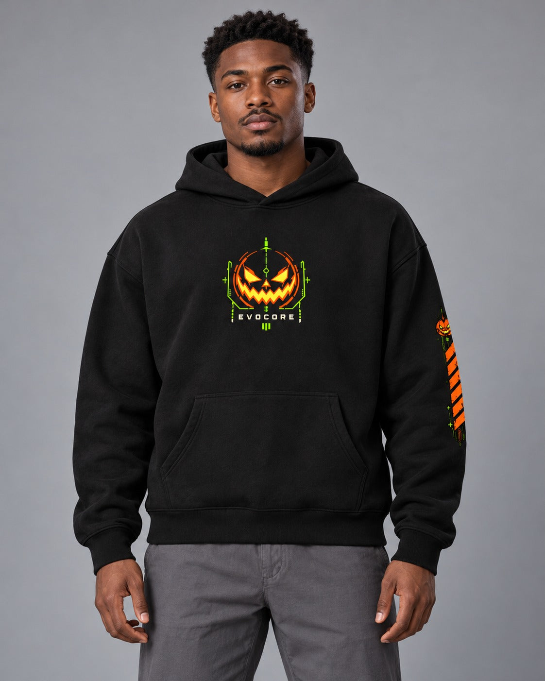 AI model visualization of the black EvoCore Pumpkin Mecha hoodie with orange and lime chest emblem and left-sleeve graphic.