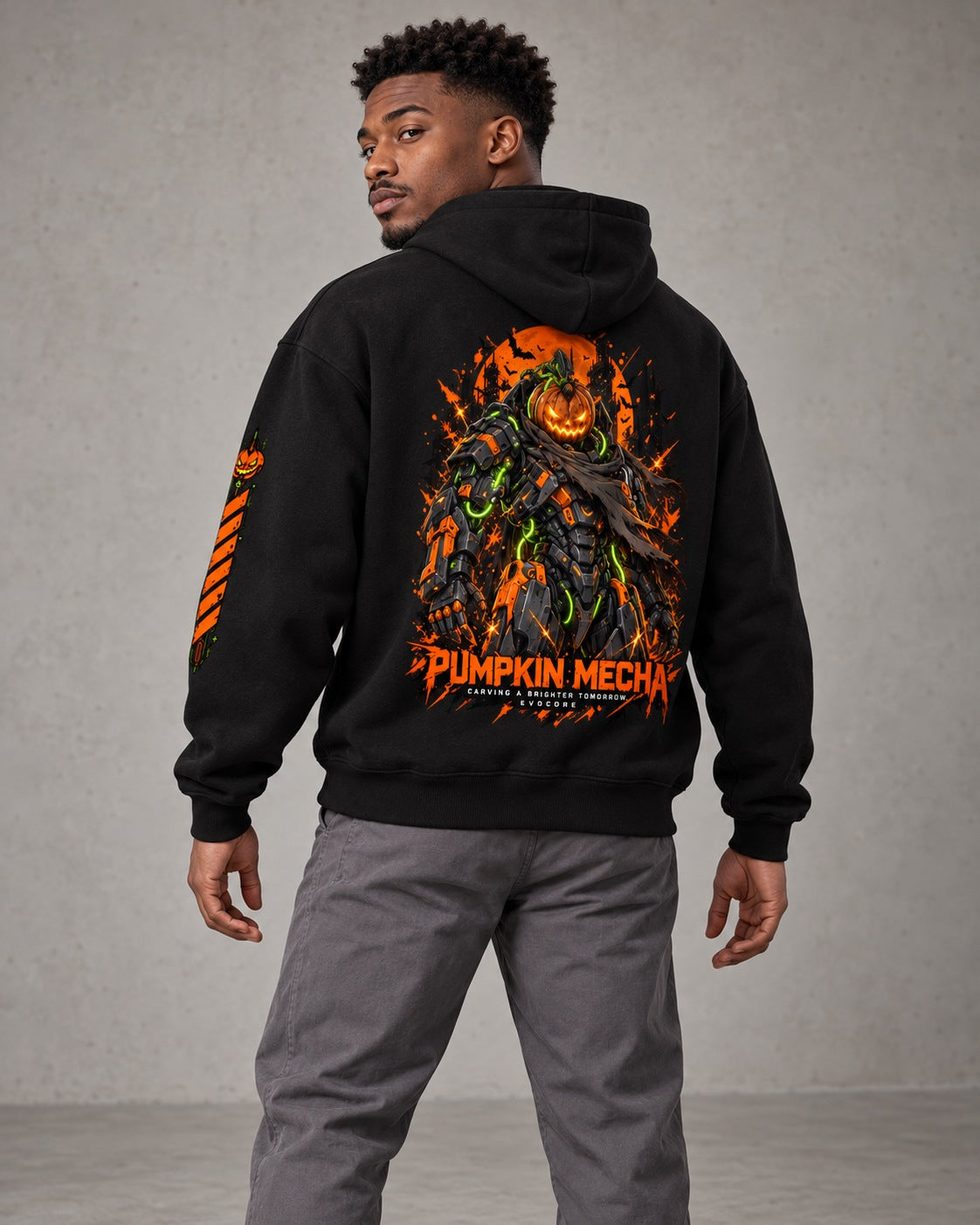 AI model visualization of the black EvoCore Pumpkin Mecha hoodie from behind, showing the orange robot graphic and left-sleeve hazard stripes.