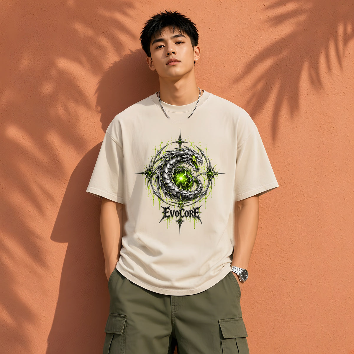 EvoCore Chrome Venom Greenwire Tee in Apricot, front view worn by a model, terracotta wall with palm shadows