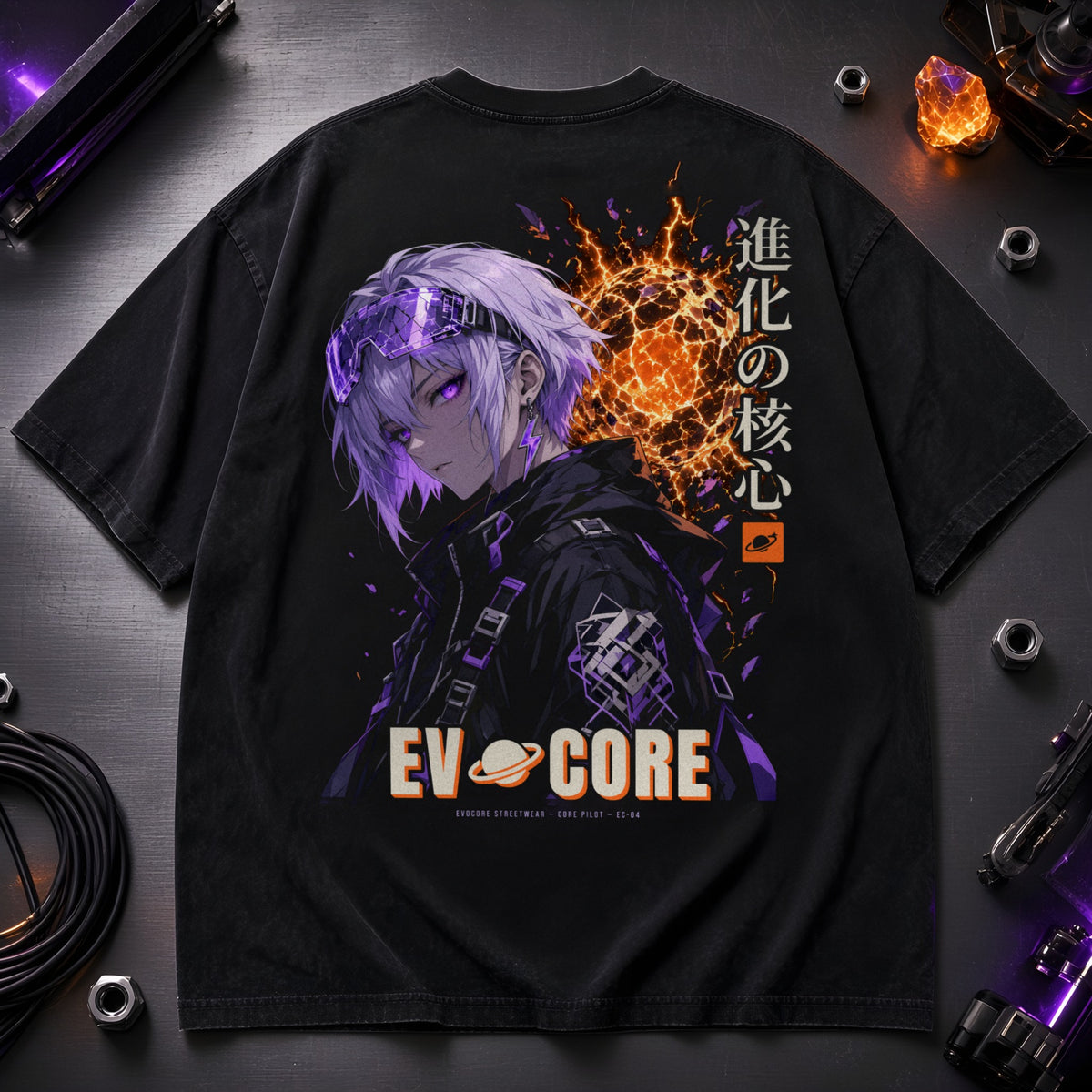 EvoCore Core Pilot Tee laid flat on brushed metal with cables and a glowing crystal, showing the full-back pilot and energy core print