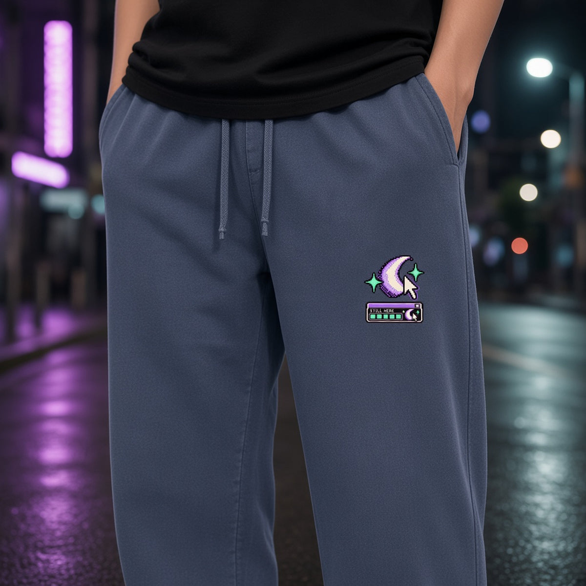 Close-up of the crescent, cursor and mint status-bar print on the left leg of EvoCore Ghost Cache Navy Blue sweatpants.