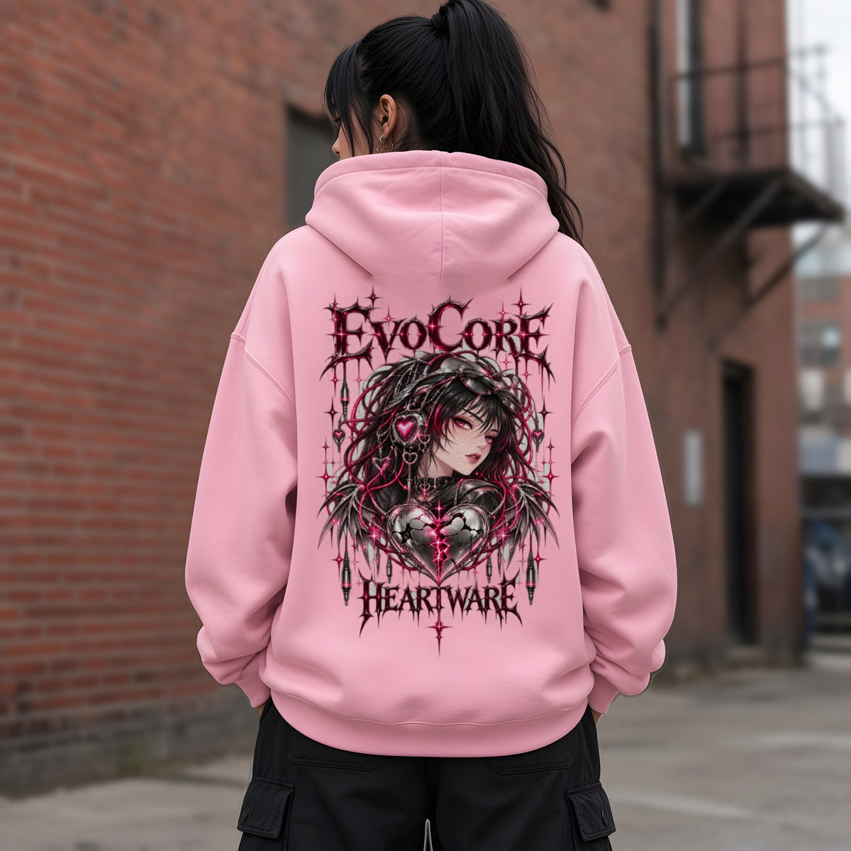 EvoCore Heartware Rose Circuit Hoodie in Pink, back view worn by a model, brick alley, daytime