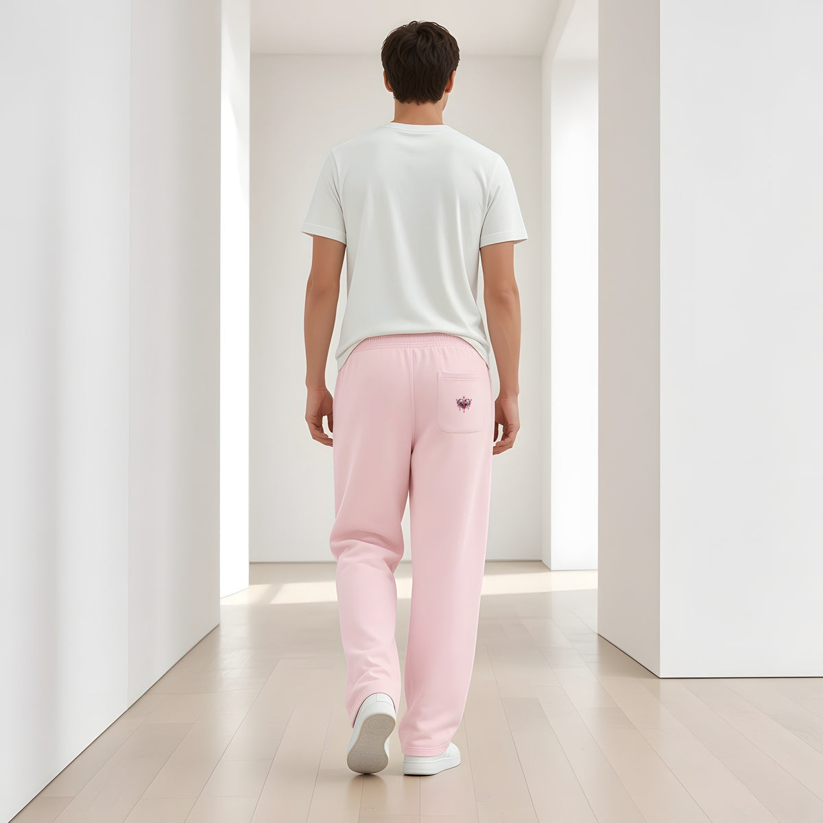 Back view of the Pink EvoCore Heartware Rose Circuit Loose Sweatpants showing the back-pocket emblem, white gallery corridor.