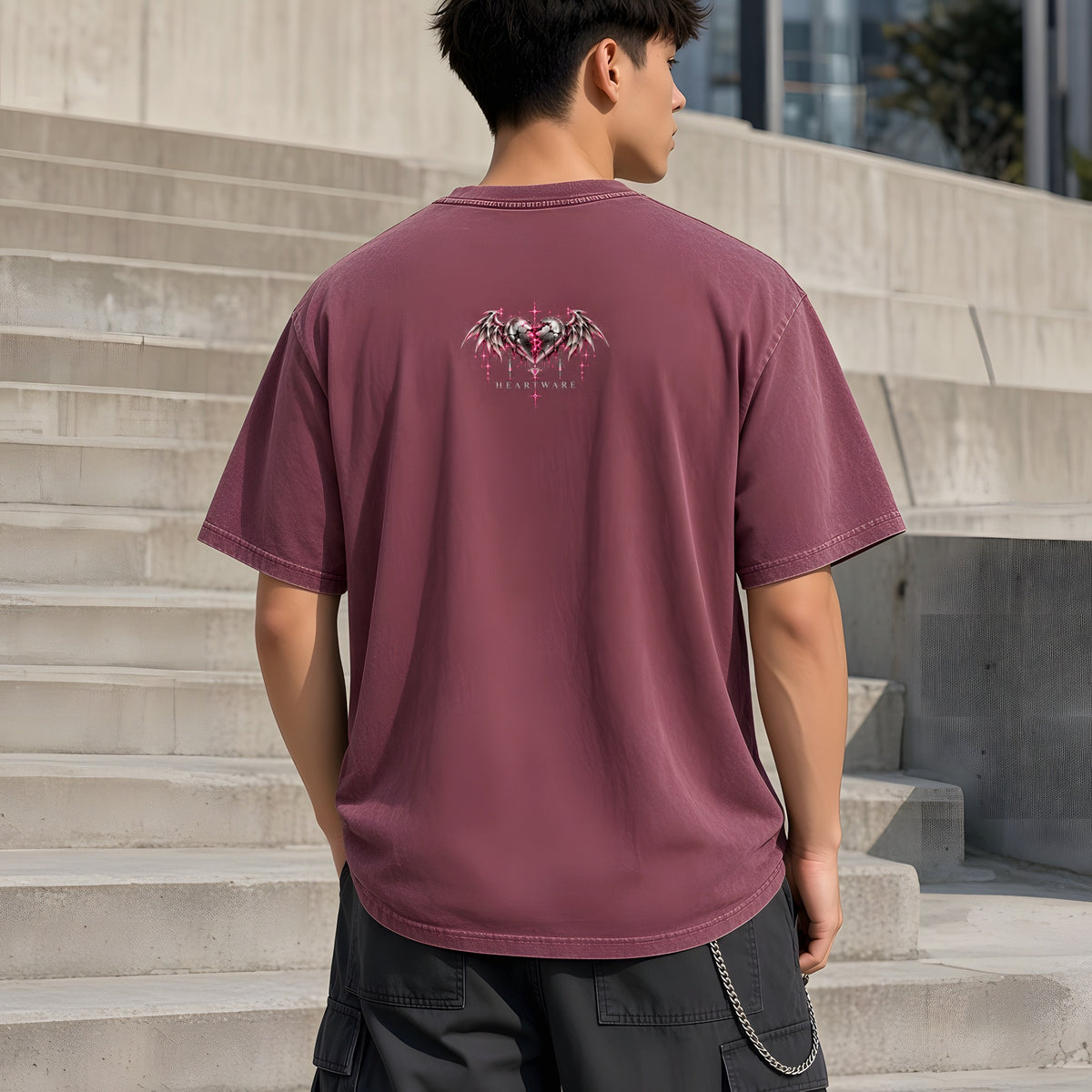 EvoCore Heartware Rose Circuit Tee in Red, back view worn by a model, sunlit concrete steps