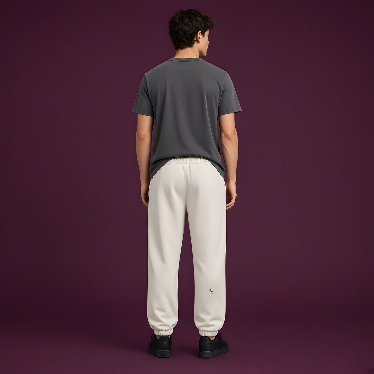 Back view of the Mild Apricot EvoCore HEX.EXE Dream Cache Joggers showing the back leg print, deep plum studio.