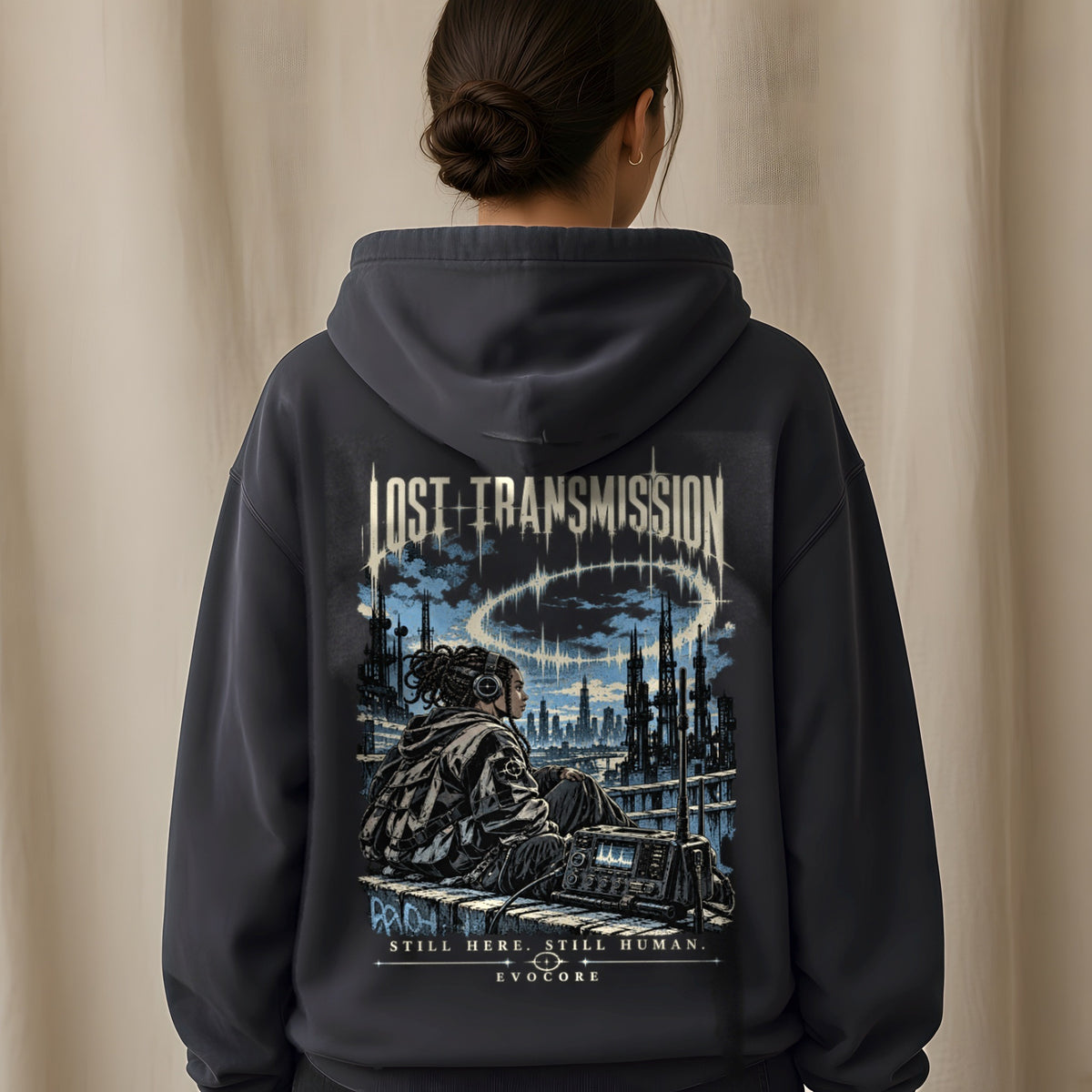 Back view of the Black EvoCore Lost Transmission Hoodie showing the back print, beige linen backdrop.