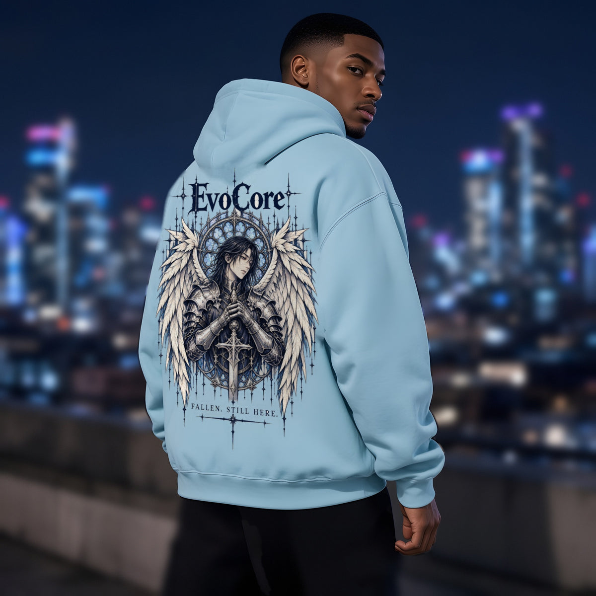 EvoCore Seraph Bluehour Hoodie in Lake Blue, back view worn by a model, rooftop at night