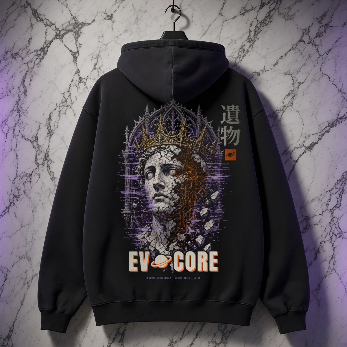 EvoCore Static Relic Hoodie hanging against a white marble wall, showing the full-back cracked statue and gold crown print