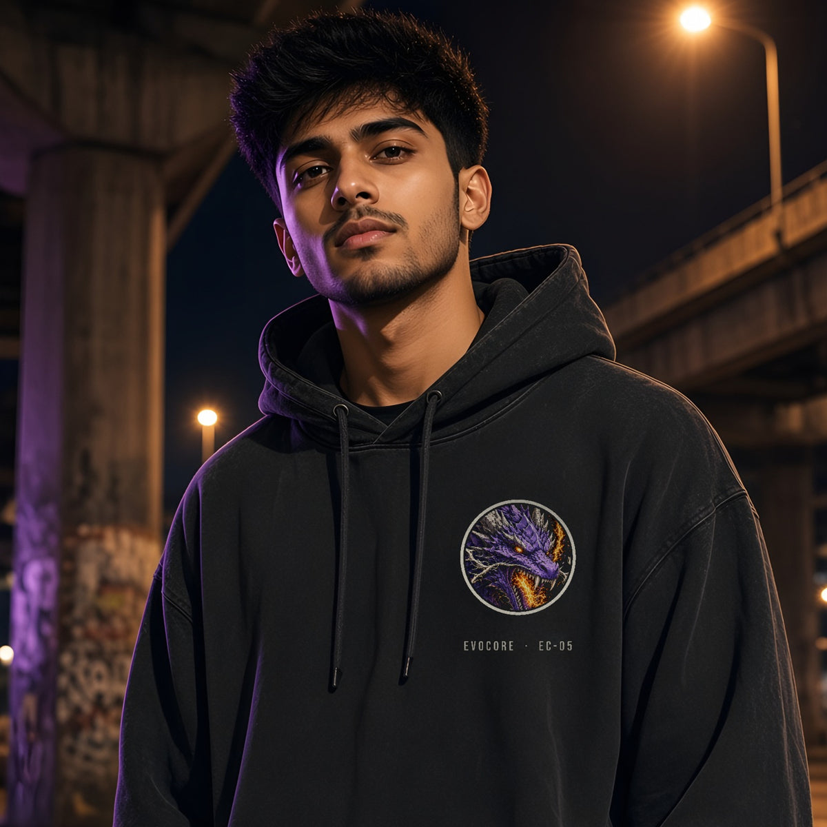 Front of the EvoCore Thunder Dragon Hoodie in washed black with the round purple dragon chest badge and EVOCORE · EC-05 text