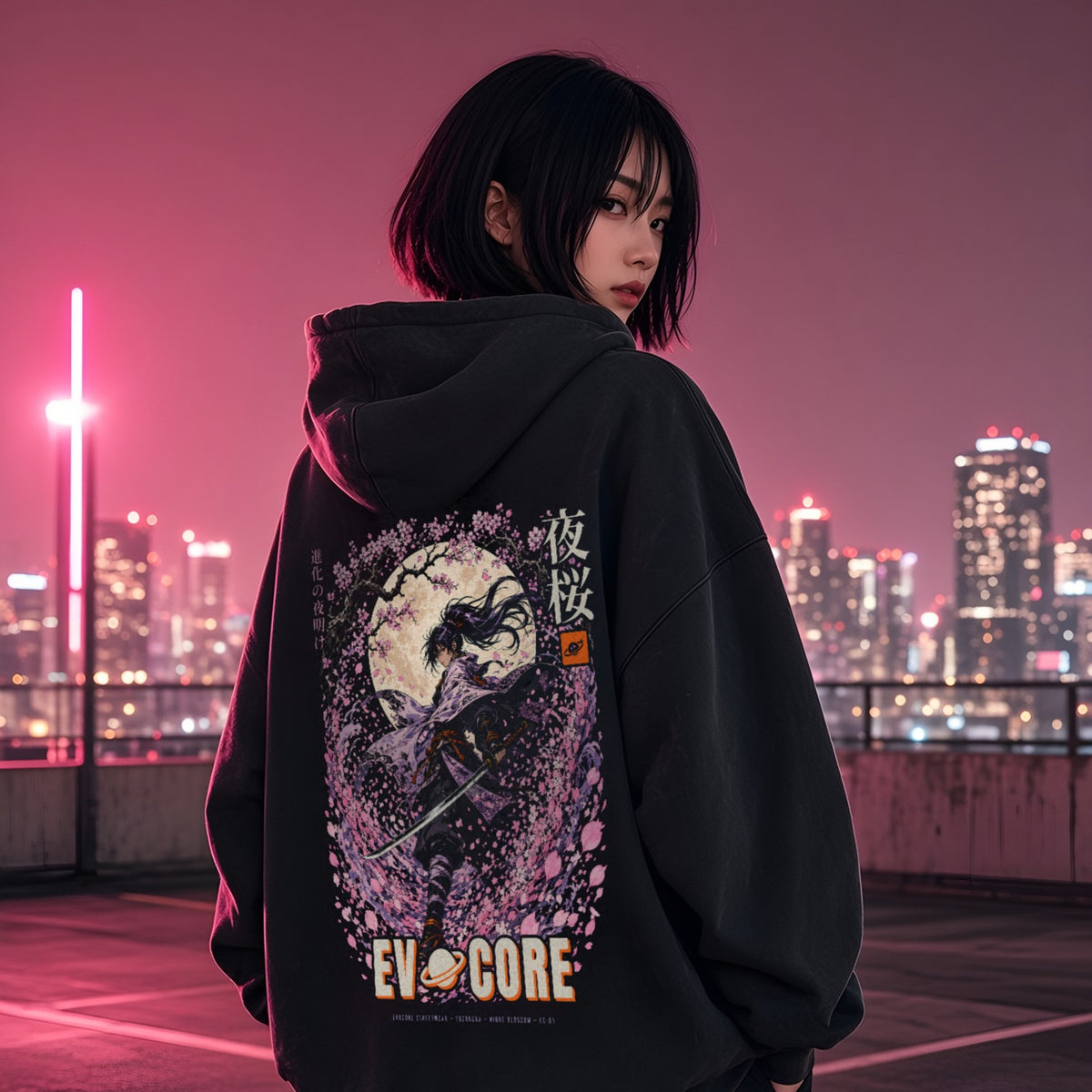 Over-the-shoulder look at the EvoCore Yozakura Hoodie on a pink-lit rooftop at night, full-back samurai and cherry blossom print