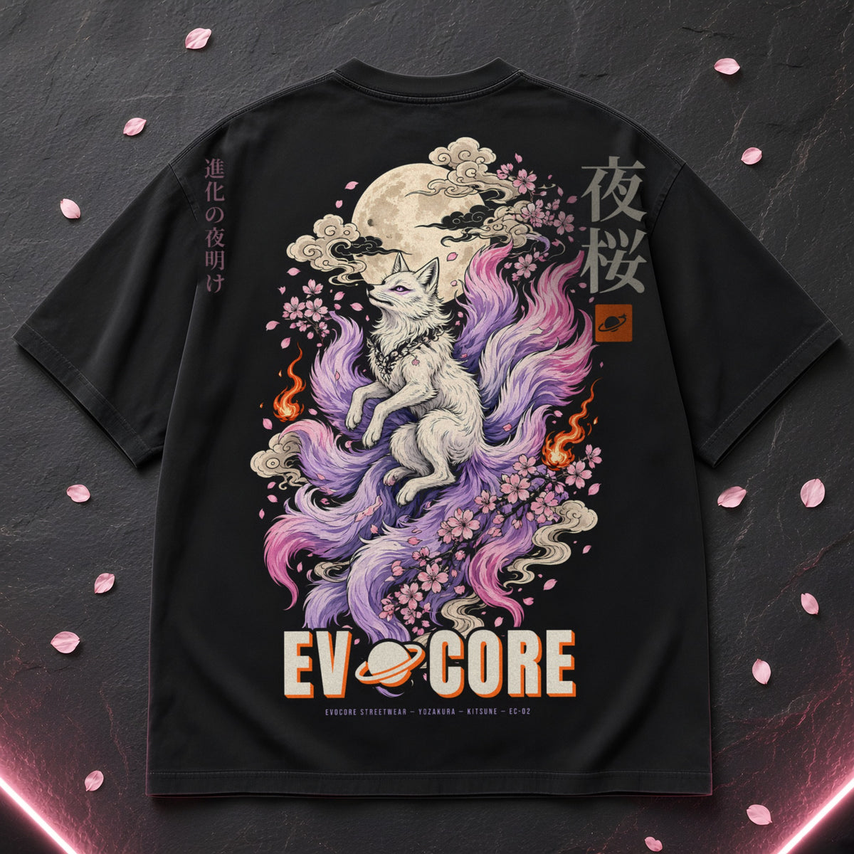 EvoCore Yozakura Tee laid flat on slate with cherry blossom petals, showing the full-back nine-tailed fox print